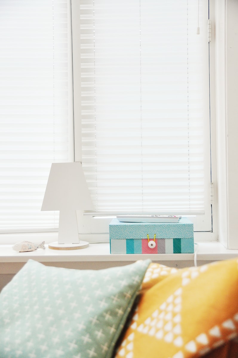 white wooden lampshade near window blinds